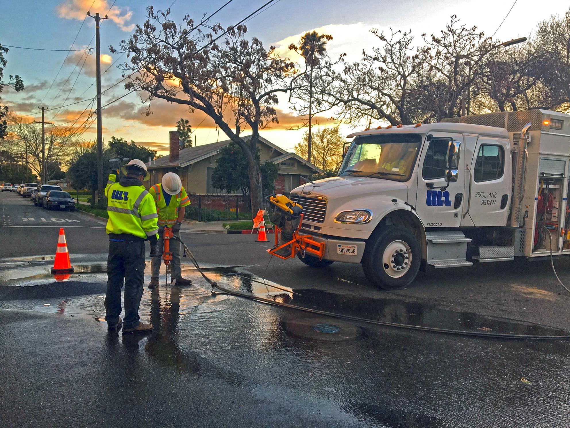 SJW crew fixing a street leak at sunset