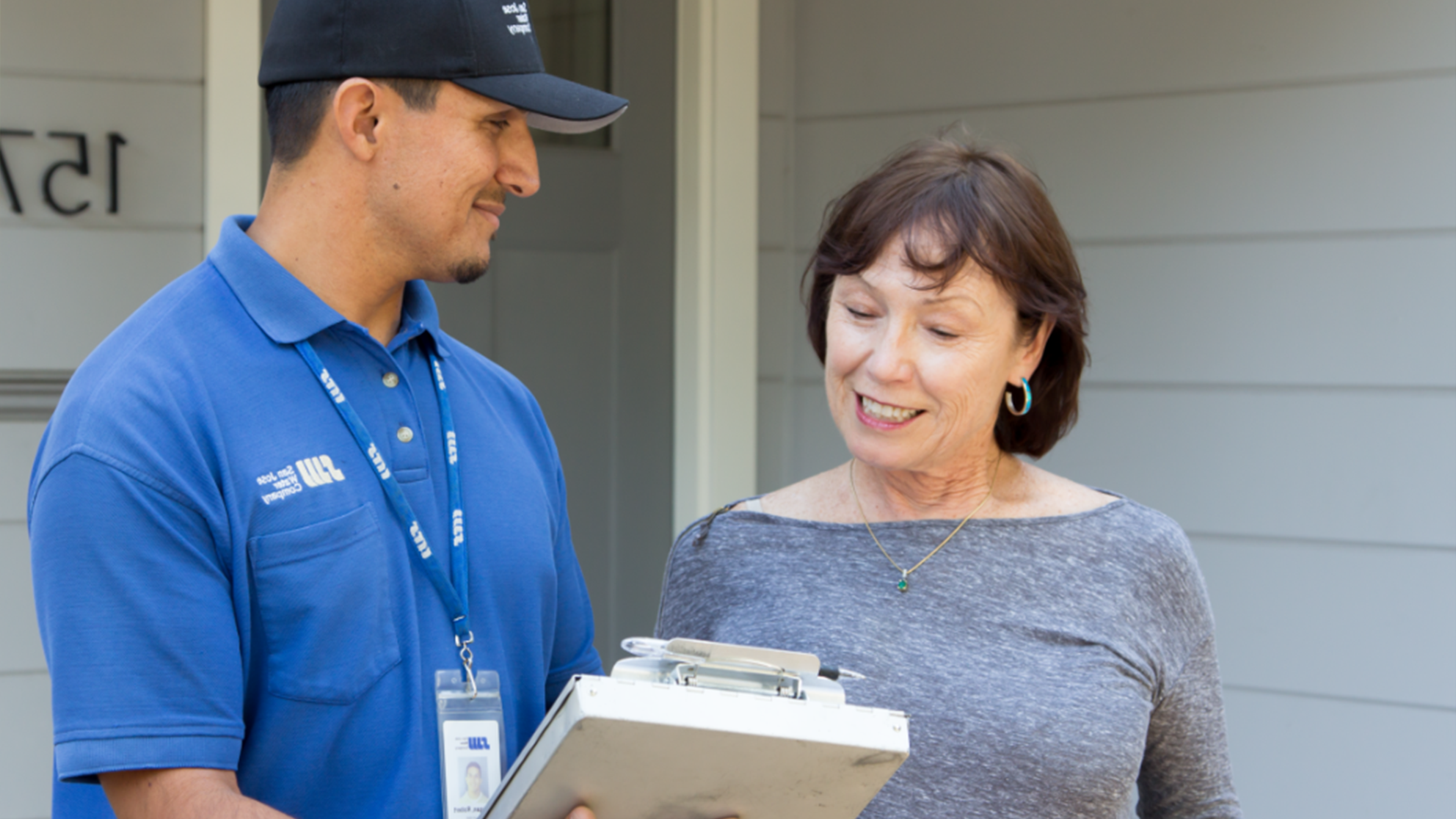 San Jose Water Rates Image - Women being helped by SJW associate in front of her house.